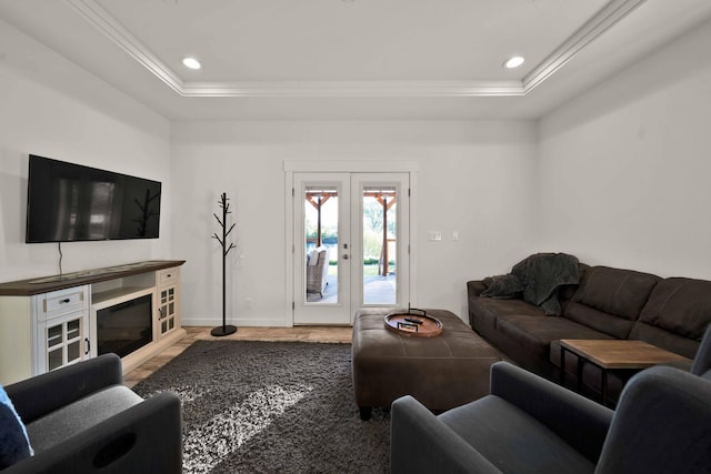 living room featuring french doors, a raised ceiling, and hardwood / wood-style floors