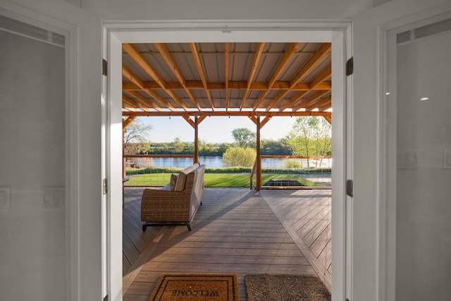 wooden terrace featuring a water view