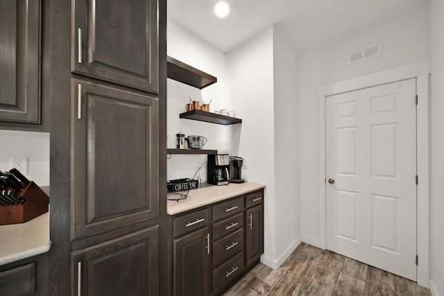 kitchen with dark brown cabinets and light wood-type flooring