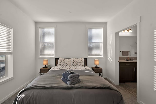 bedroom featuring ensuite bath and carpet floors