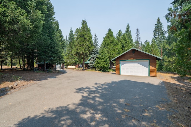 exterior space featuring a garage and an outbuilding