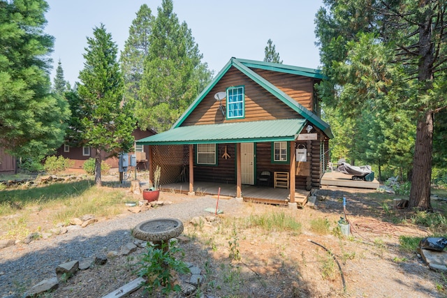 rear view of house featuring metal roof