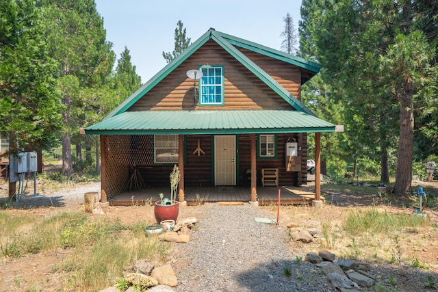 chalet / cabin featuring metal roof and log exterior