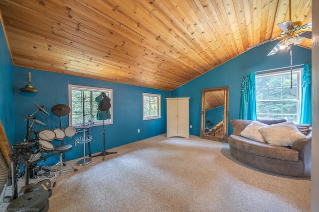 sitting room featuring carpet, wood ceiling, and vaulted ceiling