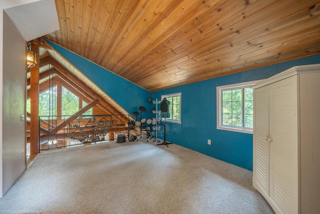 interior space featuring vaulted ceiling, wooden ceiling, and carpet flooring