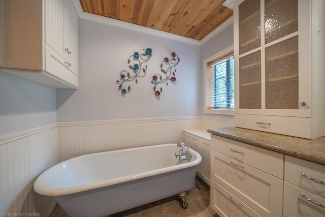 full bath with wood ceiling, a wainscoted wall, and a freestanding bath