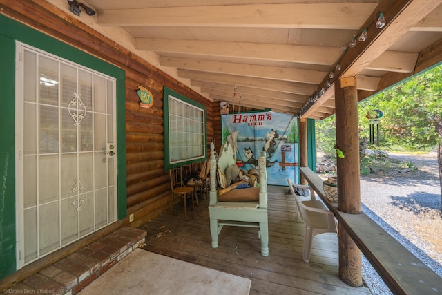 wooden terrace featuring covered porch