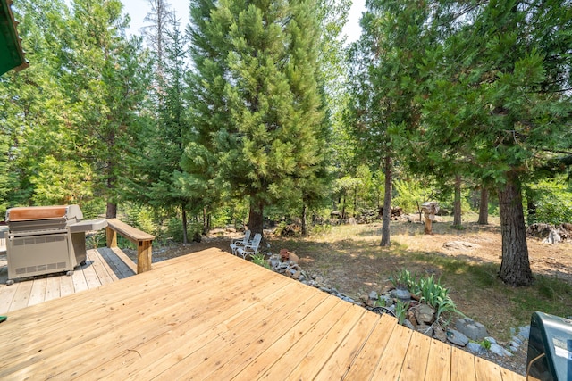 wooden deck with a grill