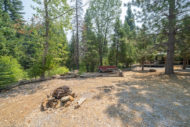 view of yard with an outdoor fire pit