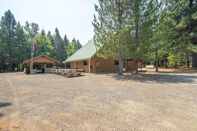 back of house with metal roof