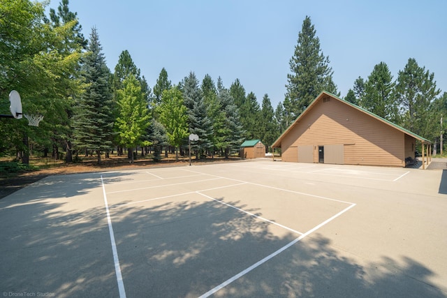 view of tennis court with community basketball court