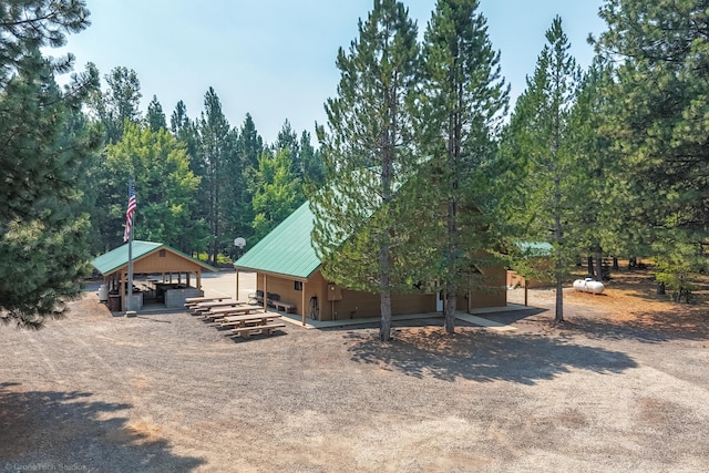 exterior space with metal roof and an outdoor structure