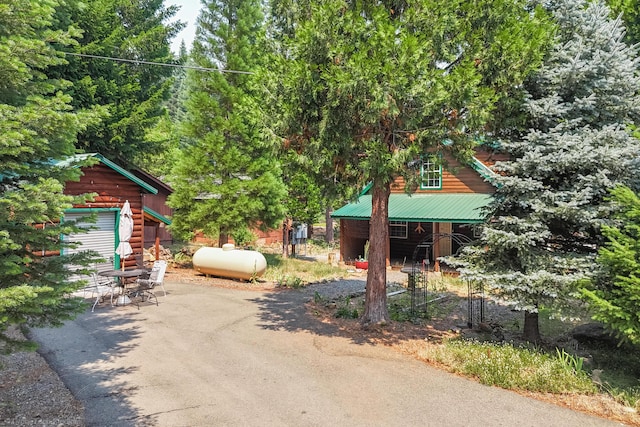 view of front of house featuring metal roof and driveway