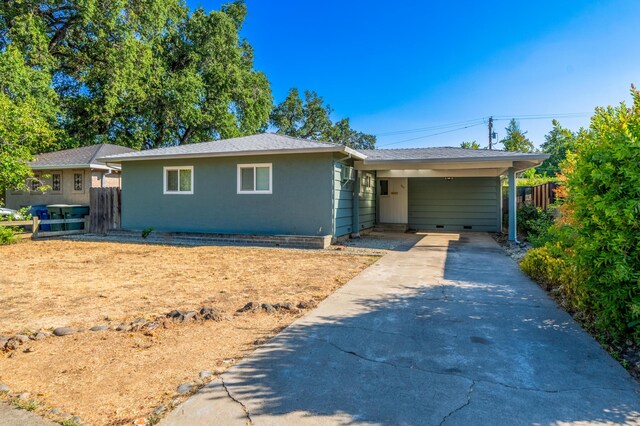 ranch-style home featuring a carport