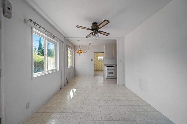 tiled empty room with ceiling fan