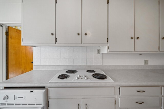 kitchen with decorative backsplash, white cabinetry, washer / clothes dryer, and white electric stovetop