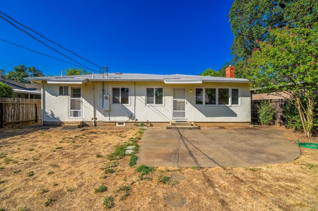 back of property with a patio