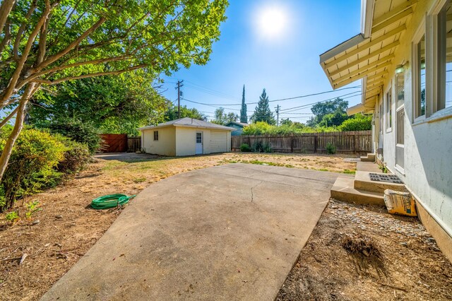 view of yard with an outbuilding and a patio area