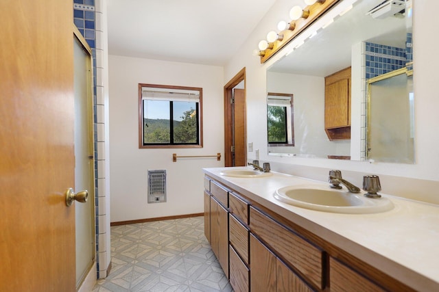 bathroom with tile patterned flooring, plenty of natural light, an enclosed shower, and double sink vanity