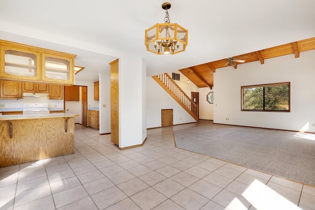 unfurnished living room with vaulted ceiling with beams, light carpet, and ceiling fan with notable chandelier