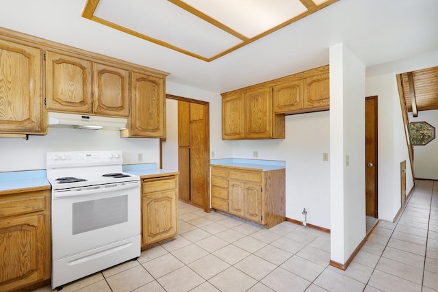 kitchen with white electric range oven and light tile patterned floors