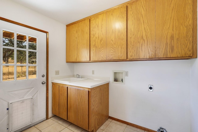 washroom with sink, electric dryer hookup, washer hookup, cabinets, and light tile patterned floors