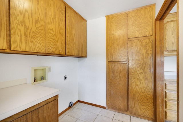 laundry room with electric dryer hookup, cabinets, hookup for a washing machine, and light tile patterned floors