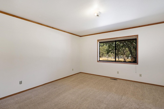 spare room with light colored carpet and ornamental molding