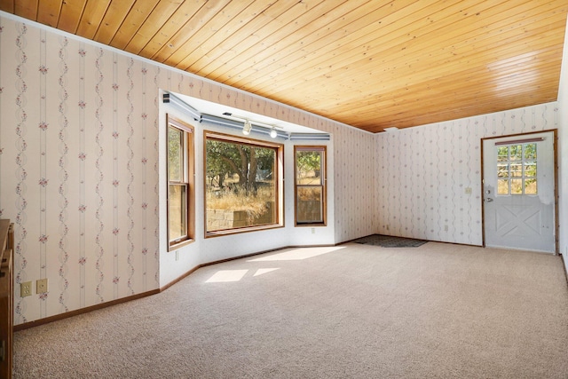 carpeted spare room with wooden ceiling