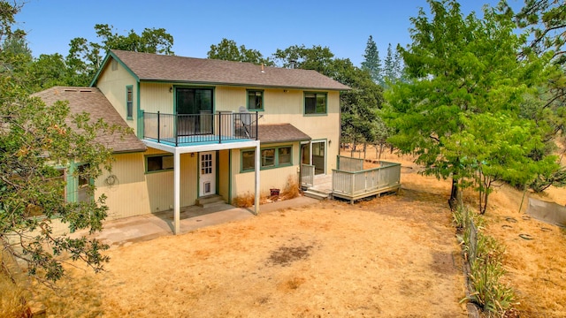 back of property with a balcony