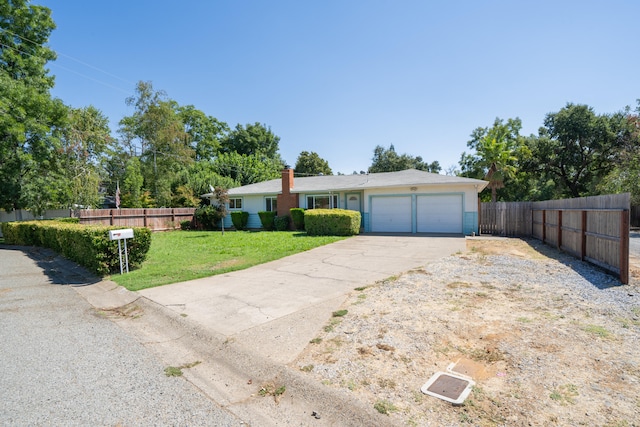 single story home featuring a front yard and a garage