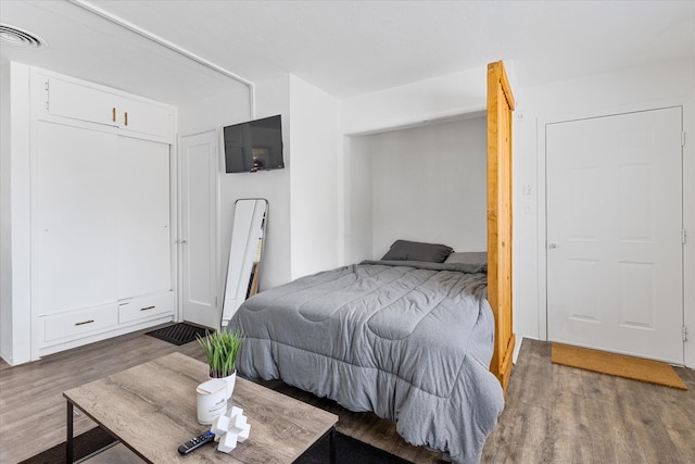 bedroom featuring dark wood-type flooring