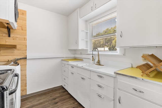 kitchen with sink, dark wood-type flooring, range with electric cooktop, and white cabinets