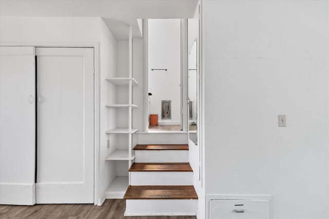 staircase featuring hardwood / wood-style flooring
