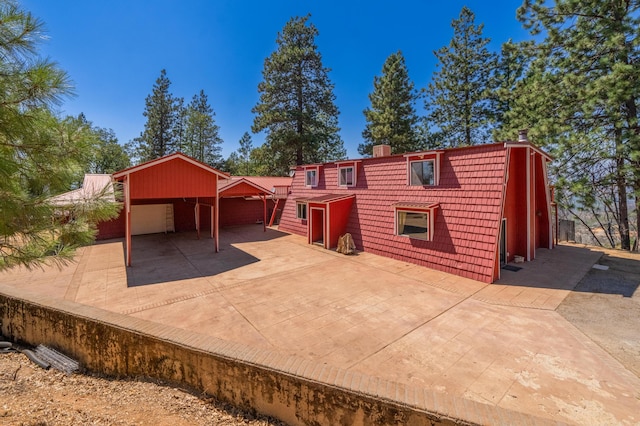 back of property featuring a carport and a garage