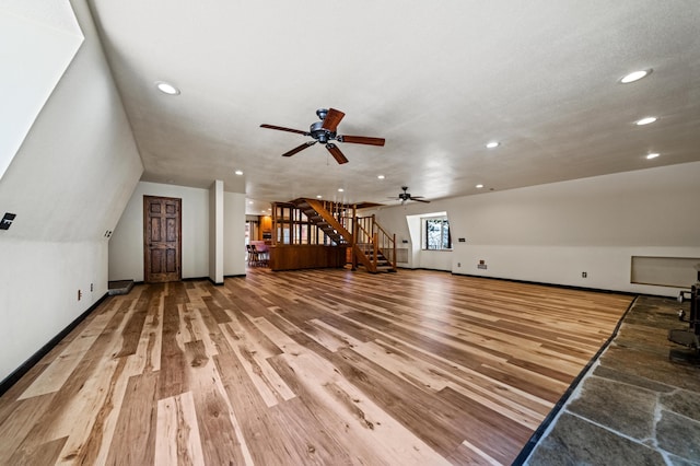 additional living space featuring light wood finished floors, stairway, recessed lighting, and baseboards