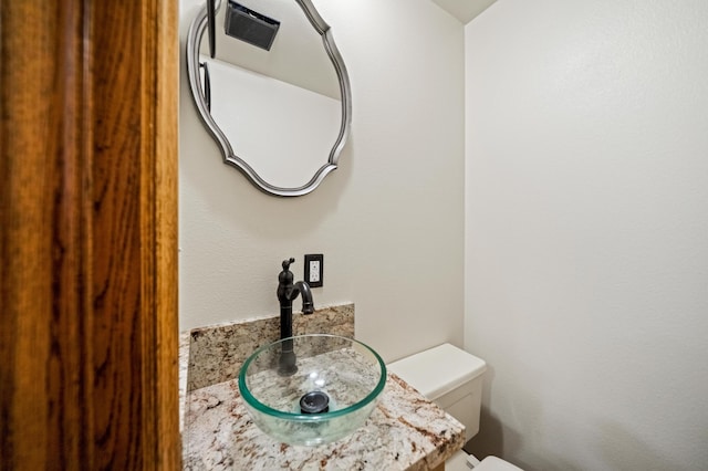 bathroom featuring toilet and sink