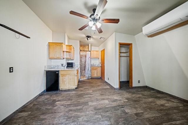 kitchen featuring visible vents, light countertops, light brown cabinetry, fridge, and a wall mounted AC