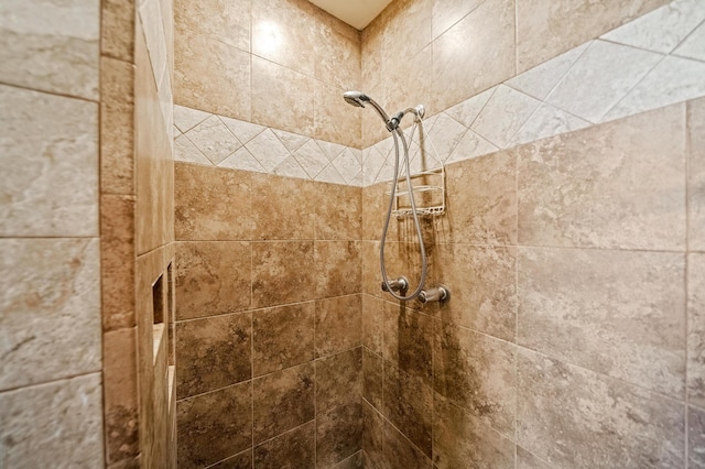 interior details with a tile shower