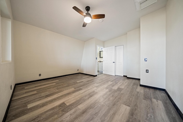 unfurnished room featuring visible vents, ceiling fan, baseboards, and wood finished floors