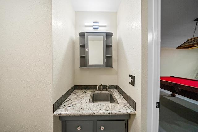 bathroom with billiards and vanity