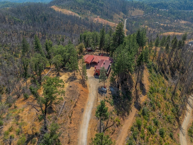 drone / aerial view with a wooded view