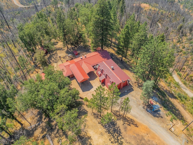 bird's eye view with a wooded view