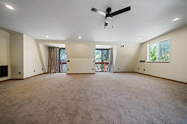 unfurnished living room featuring a healthy amount of sunlight, carpet, and recessed lighting