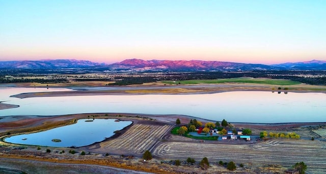 aerial view at dusk featuring a mountain view