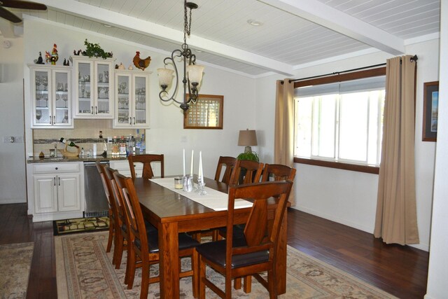 dining area featuring an inviting chandelier, dark wood-type flooring, and vaulted ceiling with beams