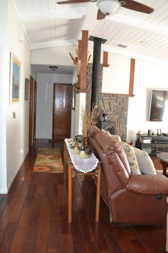 living room featuring wooden ceiling, a wood stove, lofted ceiling with beams, and hardwood / wood-style flooring