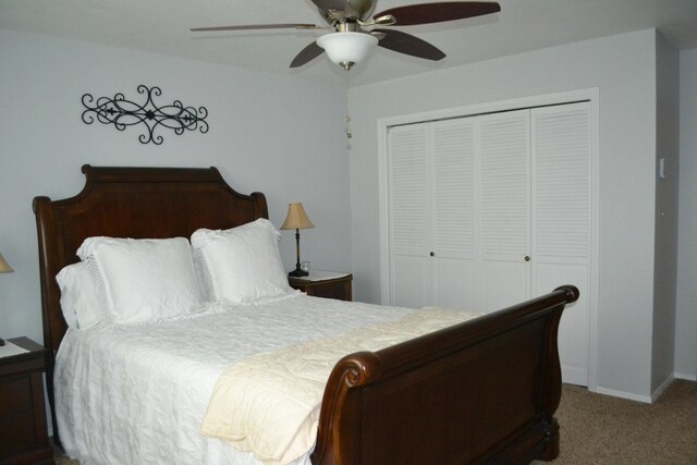 carpeted bedroom featuring a closet and ceiling fan