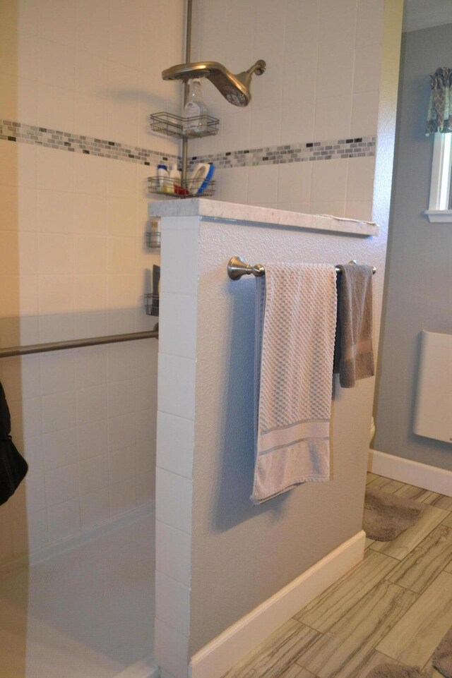 bathroom with tiled shower