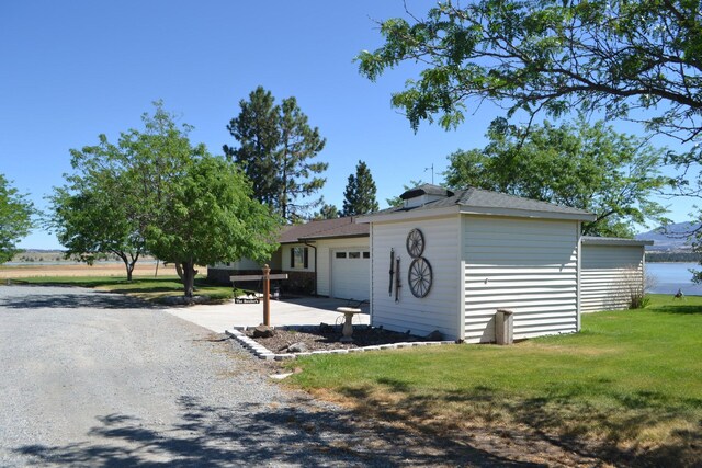 view of front of house with a garage and a front lawn